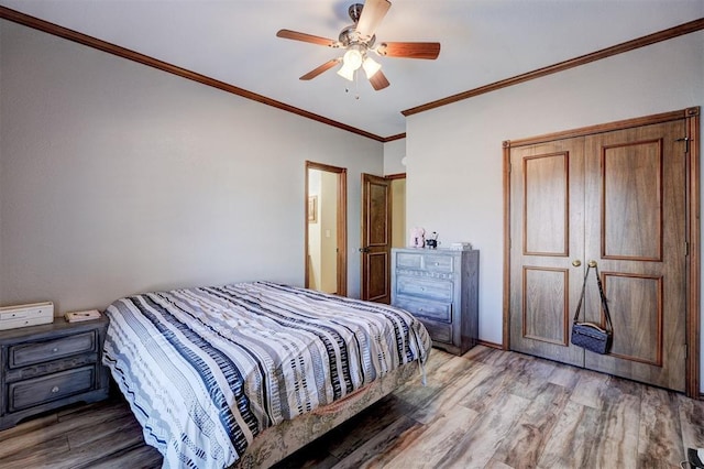 bedroom with ceiling fan, ornamental molding, and hardwood / wood-style flooring