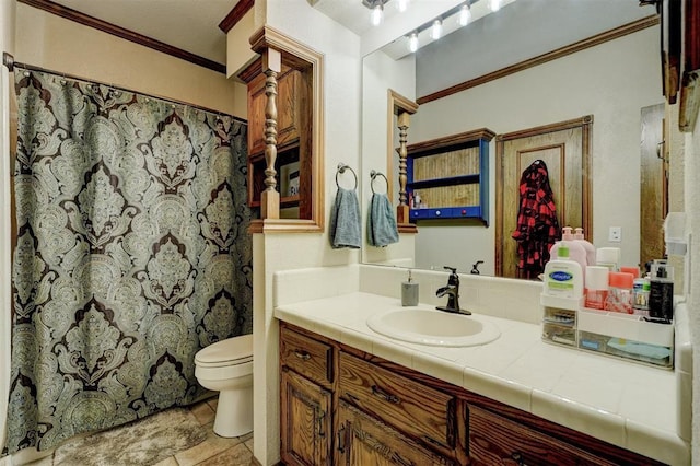 bathroom with vanity, toilet, and ornamental molding