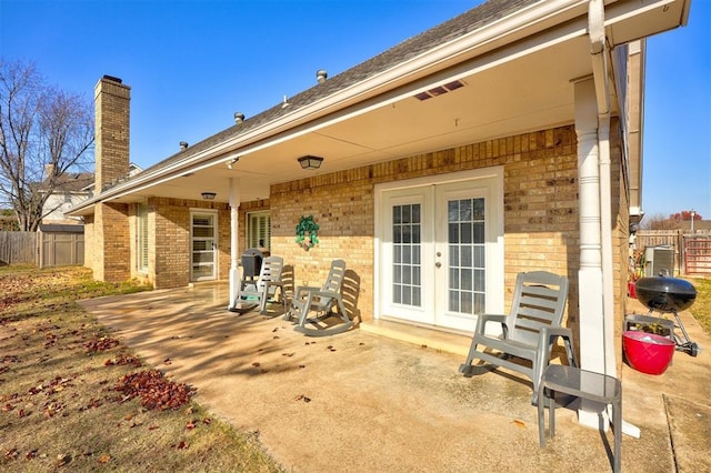 rear view of property featuring french doors and a patio area