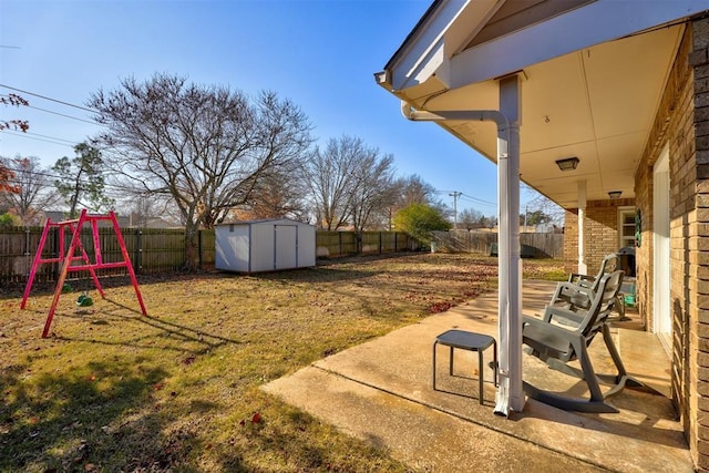 view of yard featuring a playground, a patio area, and a storage unit