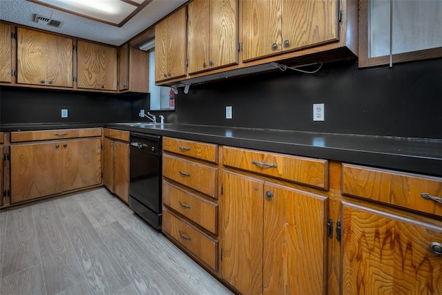 kitchen featuring black dishwasher, light hardwood / wood-style flooring, and sink