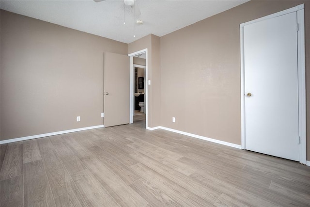 unfurnished bedroom with ceiling fan and light hardwood / wood-style flooring