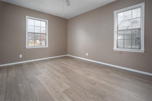 unfurnished room featuring ceiling fan and light hardwood / wood-style flooring