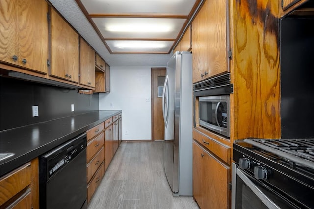 kitchen with stainless steel appliances and light hardwood / wood-style flooring