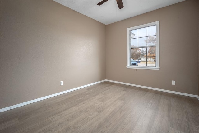 unfurnished room with hardwood / wood-style floors and ceiling fan