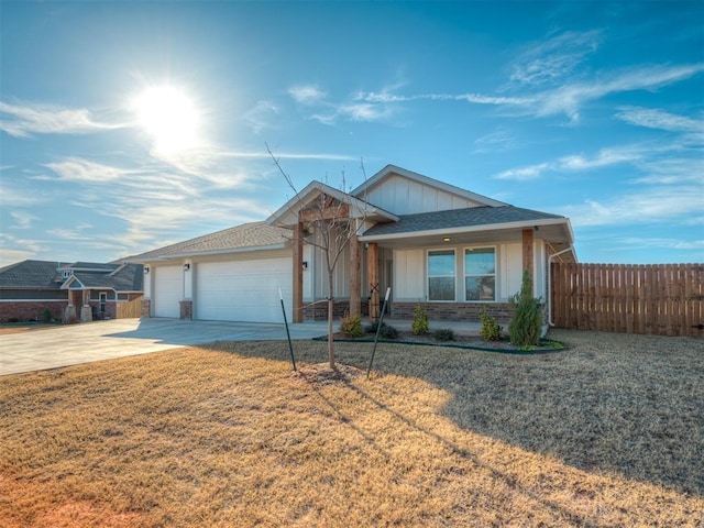 ranch-style house featuring a front yard and a garage