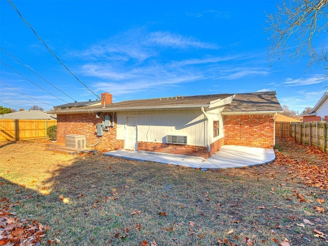 rear view of house with central AC and a patio area