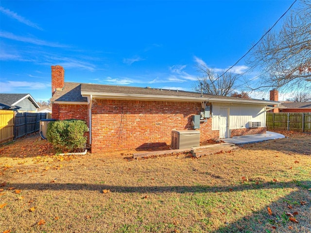 rear view of property featuring a lawn