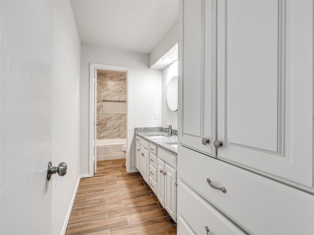 full bathroom with vanity, toilet, and tiled shower / bath