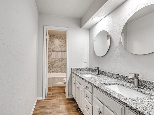 full bathroom featuring vanity, toilet, and tiled shower / bath combo