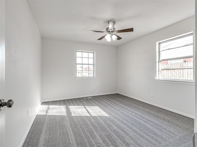 empty room featuring ceiling fan and carpet floors