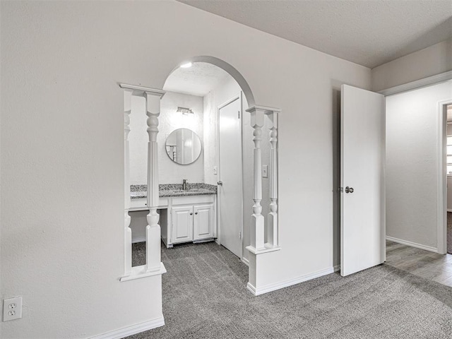 bathroom featuring a textured ceiling and vanity