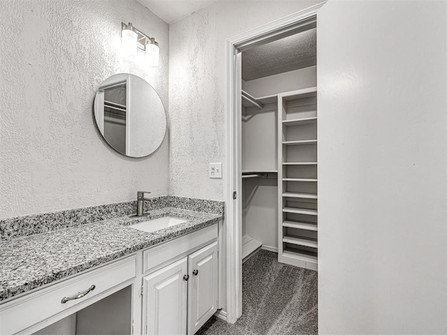 bathroom featuring vanity and a textured ceiling