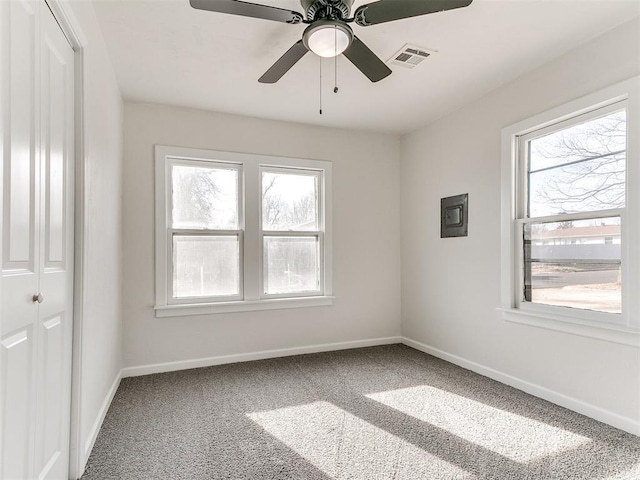 carpeted spare room with ceiling fan