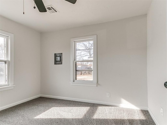 unfurnished room featuring carpet, plenty of natural light, and ceiling fan