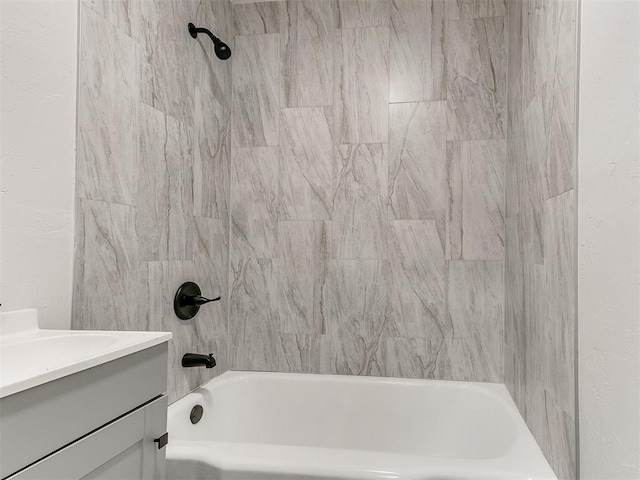 bathroom with vanity and tiled shower / bath combo