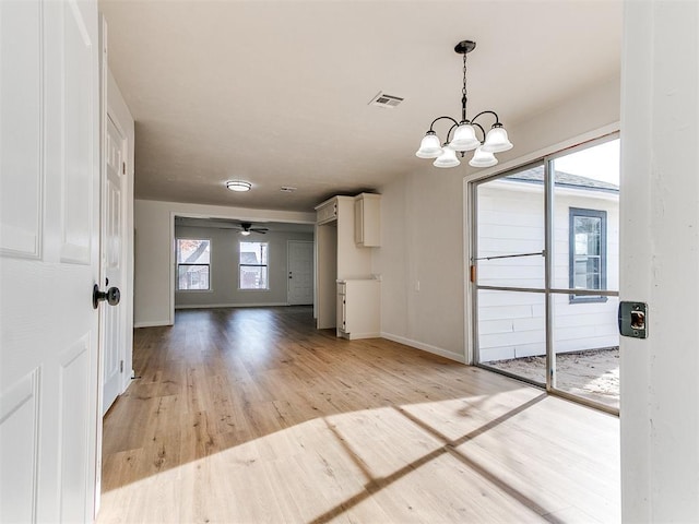 interior space with light hardwood / wood-style floors and ceiling fan with notable chandelier