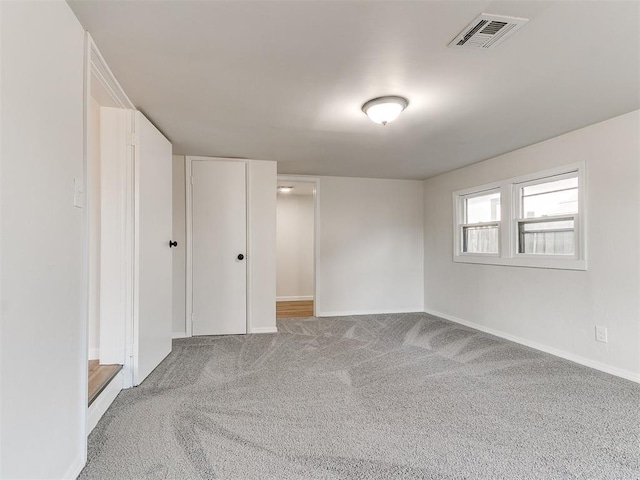 unfurnished room featuring light colored carpet