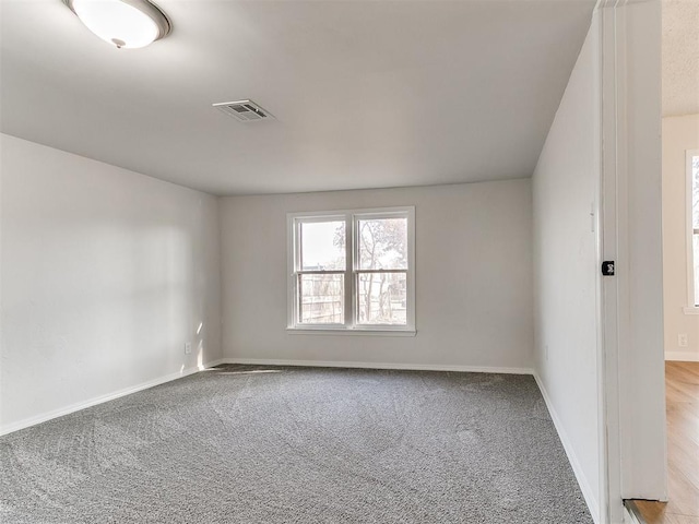 unfurnished room with light carpet