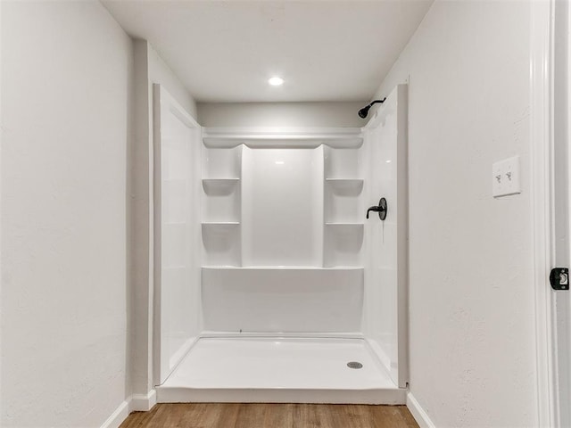 bathroom featuring hardwood / wood-style floors and walk in shower