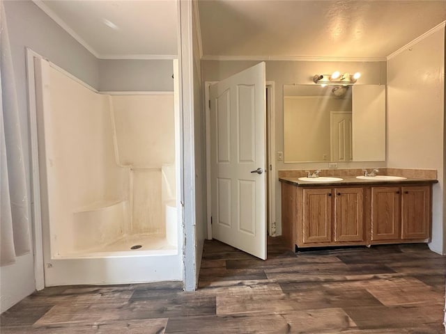 bathroom featuring hardwood / wood-style floors, vanity, and ornamental molding