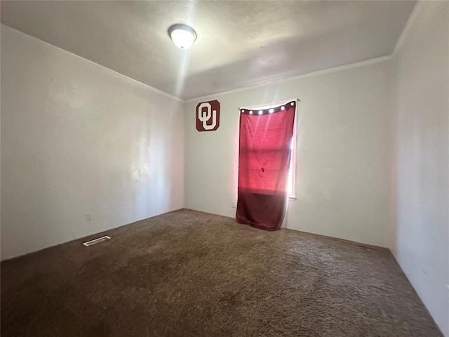 carpeted empty room featuring crown molding