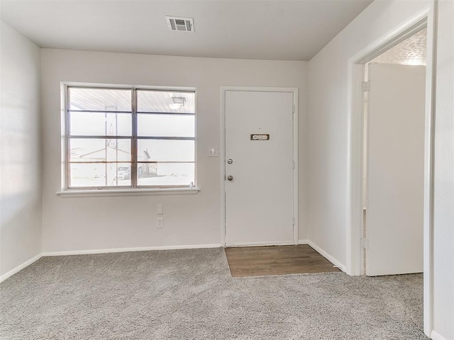 carpeted foyer entrance featuring a healthy amount of sunlight