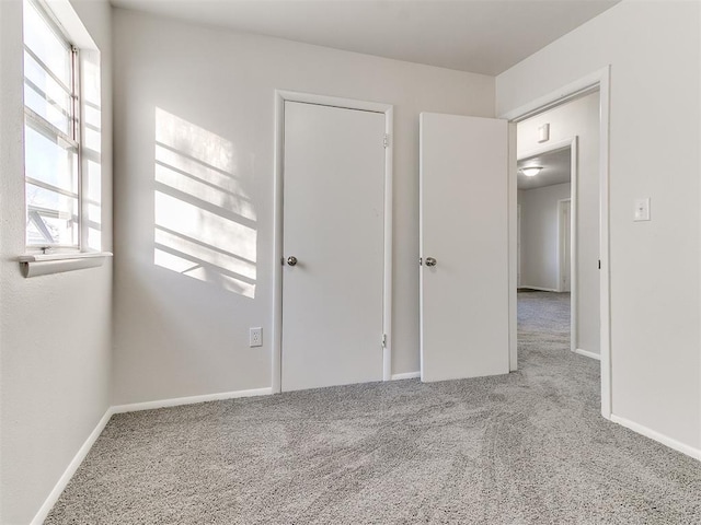 empty room with plenty of natural light and carpet