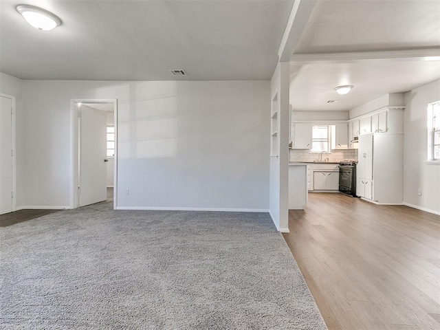 unfurnished living room with light carpet