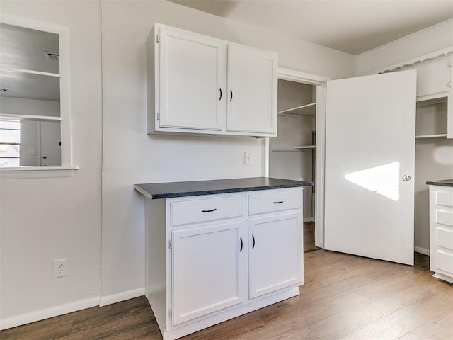 kitchen with white cabinets and hardwood / wood-style flooring