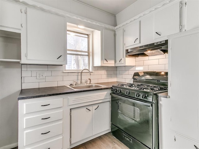 kitchen with white cabinets, backsplash, gas stove, and sink