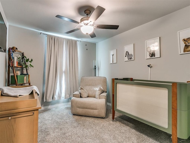 living area featuring carpet and ceiling fan