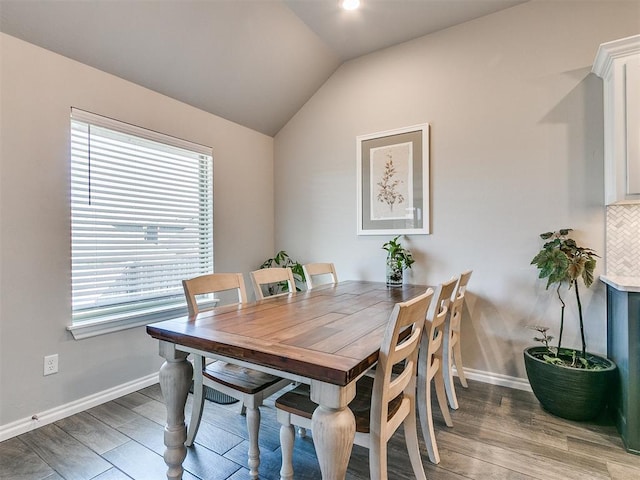 dining room with hardwood / wood-style floors and lofted ceiling