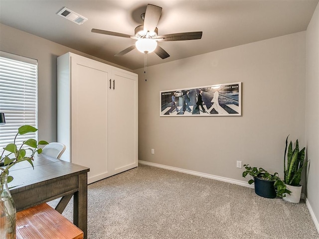 office with light colored carpet and ceiling fan