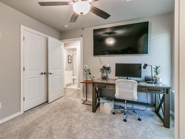 office space with light carpet and ceiling fan