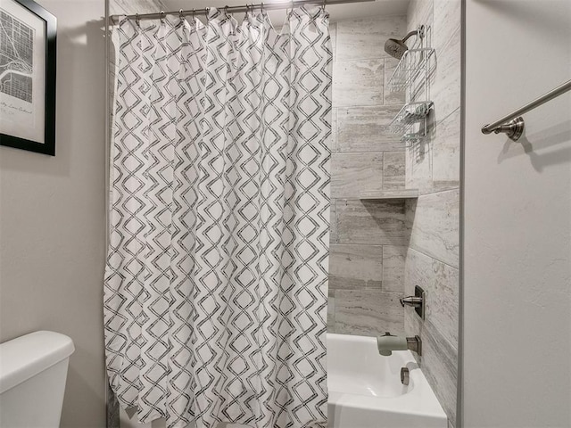 bathroom featuring toilet and shower / bath combo with shower curtain