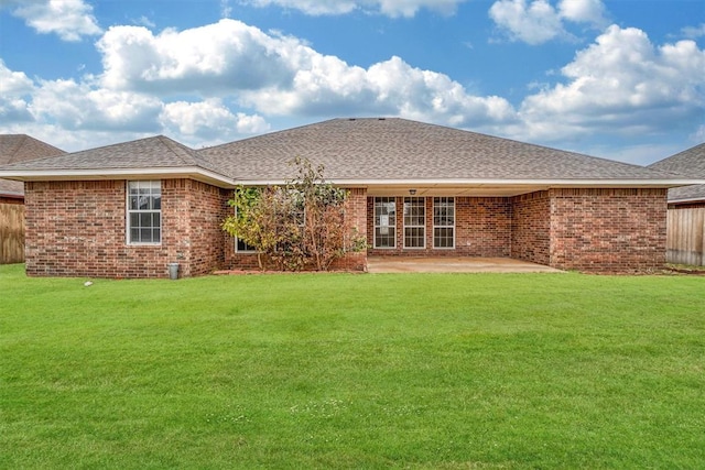 back of house featuring a patio and a lawn