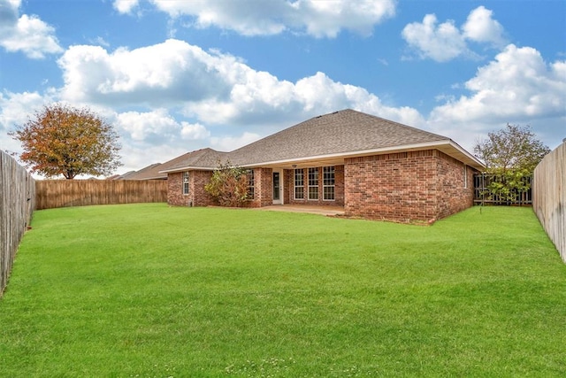 rear view of property with a lawn