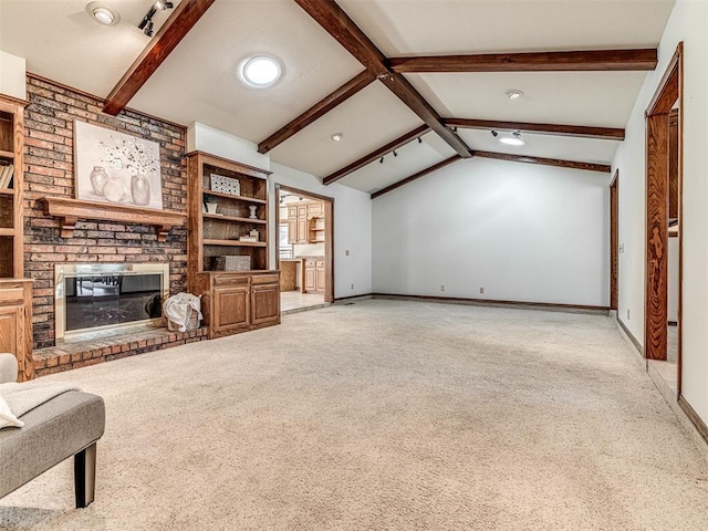 unfurnished living room featuring lofted ceiling with beams, light colored carpet, and a fireplace