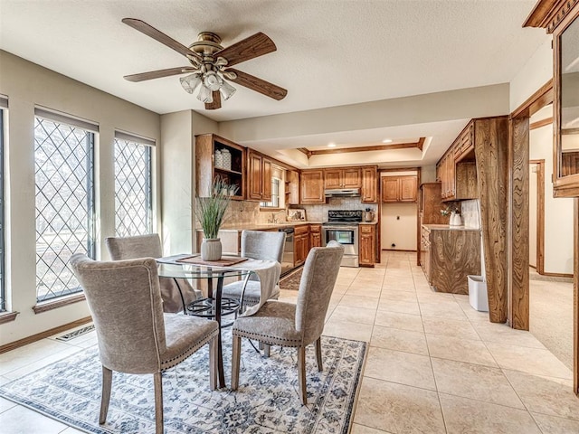 tiled dining area featuring sink, a textured ceiling, a wealth of natural light, and ceiling fan