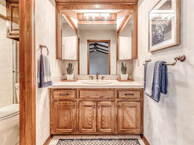 bathroom with tile patterned flooring, vanity, and toilet