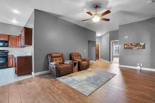 103 Ranch Rd, Elk City, OK 73644 - sitting room with light wood-type flooring, vaulted ceiling, ceiling fan, and sink