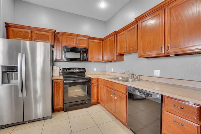 103 Ranch Rd, Elk City, OK 73644 - kitchen featuring black appliances, light tile patterned floors, and sink