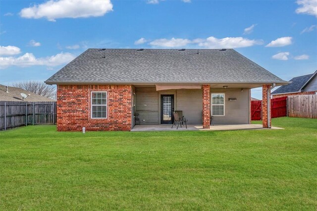 103 Ranch Rd, Elk City, OK 73644 - back of house featuring a patio and a lawn