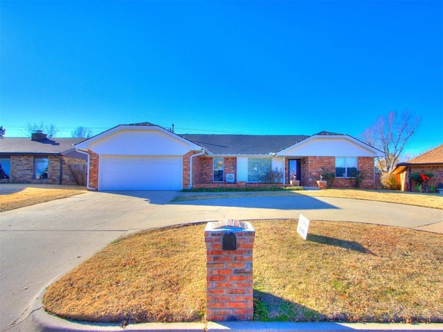 single story home with a front yard and a garage