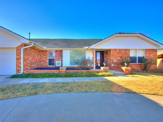 ranch-style house with a front yard and a garage