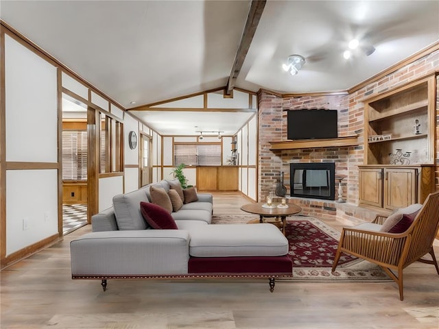 living room with a fireplace, built in shelves, vaulted ceiling with beams, and light hardwood / wood-style floors