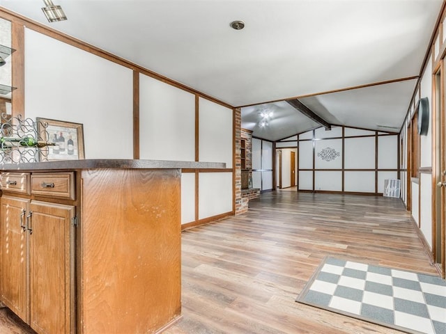 interior space featuring lofted ceiling with beams and light hardwood / wood-style floors