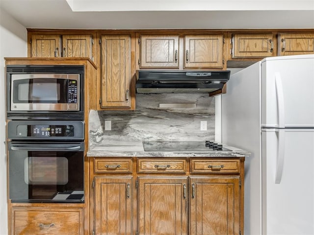 kitchen featuring backsplash and black appliances