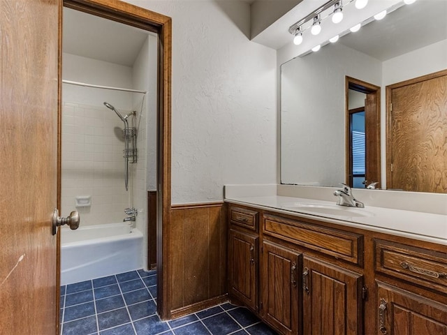 bathroom featuring tile patterned floors, vanity, and tiled shower / bath